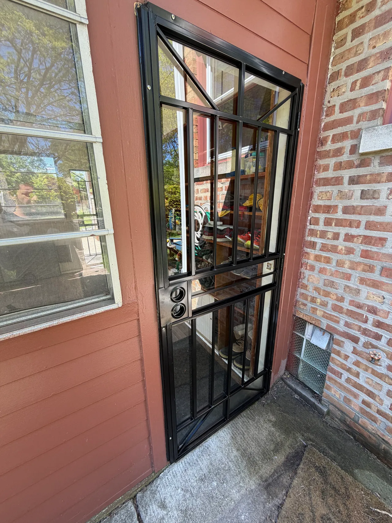 Black entry door with glass panels on a Skokie house