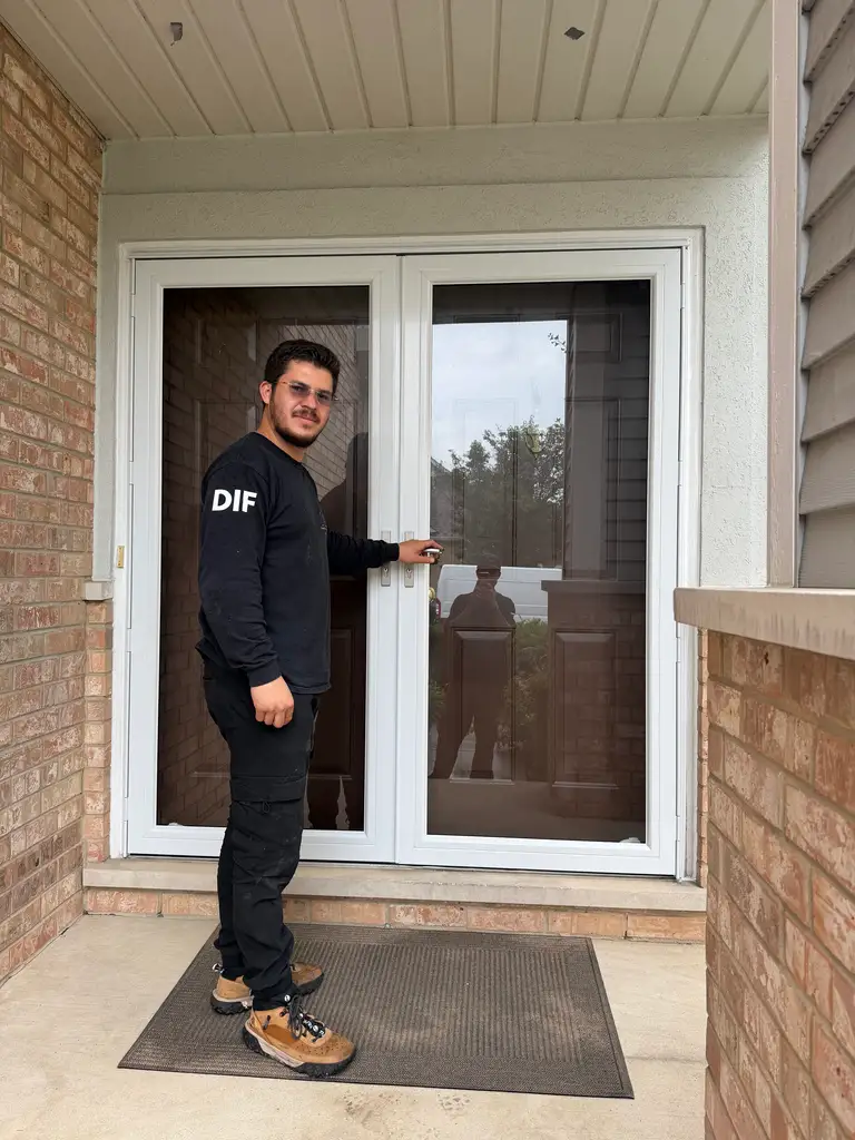 Diego Ivan, owner and lead technician, at a patio door